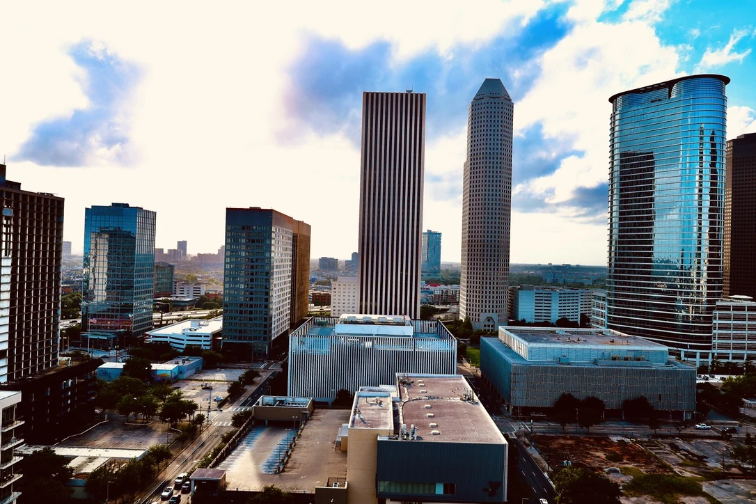 Elevated view of the Houston downtown skyline under a dramatic cloudy sky