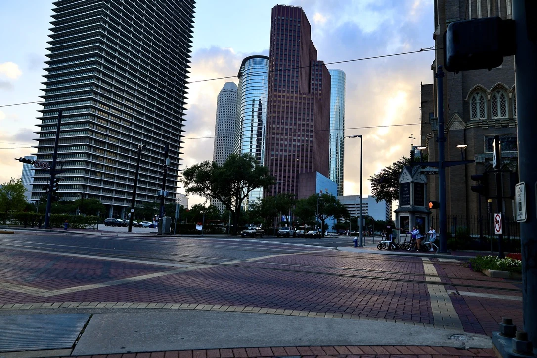 Downtown Houston street corner with skyscrapers and a church spire