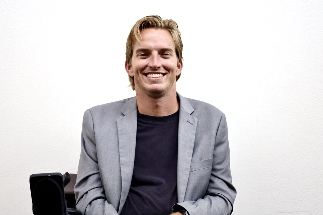Man in a grey blazer, warm studio portrait