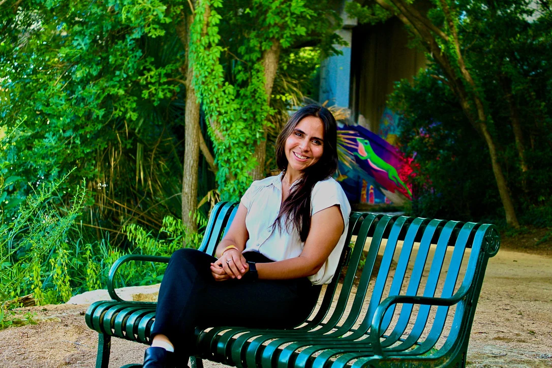 Woman seated on a garden bench, environmental portrait